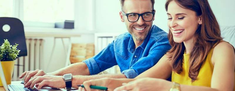 Couple smiling at desk