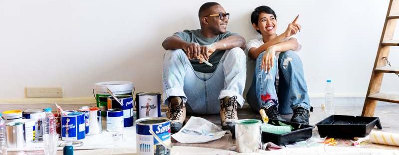 Two people painting a room