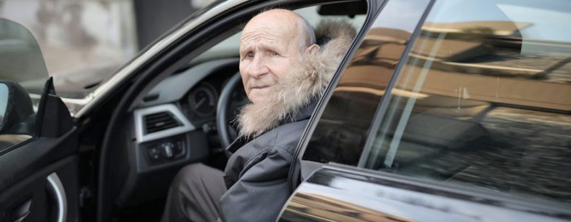 Elderly man in car