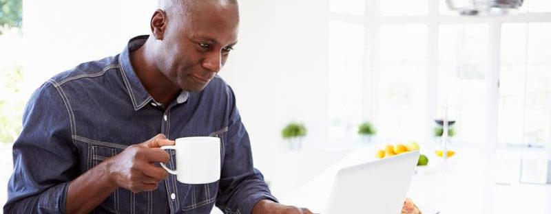 Man with coffee and laptop