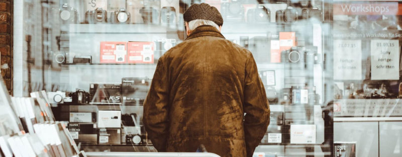 Senior standing in front of storefront